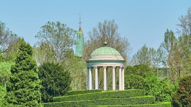 Parco Querini is green area of city of Vicenza, Italy. Monopteros is circular colonnade supporting roof but without any walls. Unlike tholos, it does not have walls making cella or room inside.