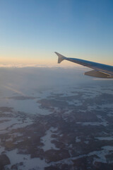 Fototapeta premium Snowy winter landscape in Finnish Lapland view from an airplane window