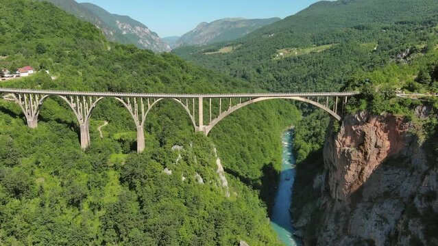 Aerial tilt view on Djurdjevica arch bridge over the Tara River in northern Montenegro, 4k