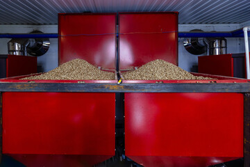 Piles of bio fuel pellets in boiler room