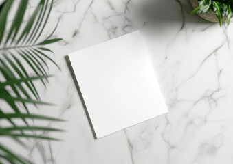 Advertising close up mockup shot of empty white flyer paper lies on white marble coffee table and areca palm decorations around