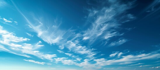 Tranquil panoramic view of beautiful blue sky with fluffy white clouds on a sunny day - obrazy, fototapety, plakaty