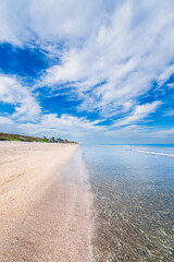 Fototapeta na wymiar beach and sea with clouds in blue sky