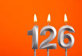 126 candle - Birthday celebration on orange background