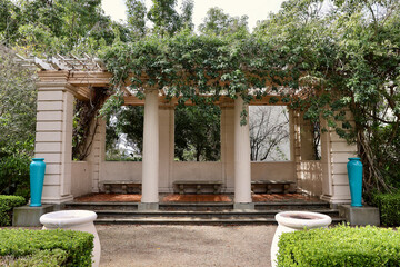 Vine covered trellis in a vintage formal garden