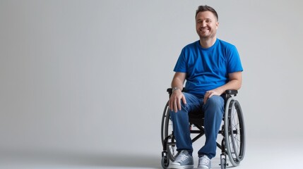 white man with a physical disability smiling and sitting in a wheelchair dressed in jeans, a blue t-shirt, positioned against a white background, Fashion mockup, Lifestyle, Stylish studio background