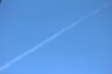 Fototapeta na wymiar sky with ascending diagonal line. blue sky with the path taken. diagonal line in the sky.