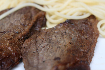 beef with pasta. spaghetti with meat. food with selective focus.