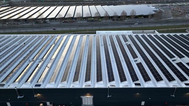 Top view Solar Cell on Warehouse Factory. Solor photo voltaic panels system power or Solar Cell on industrial building roof for producing green ecological electricity. Production of renewable energy.