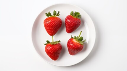 Strawberries, on a white round plate, on a white background, top view