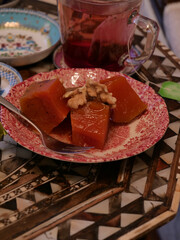 Traditional Turkish pumpkin dessert (kabak tatlisi) photo in close view with tea