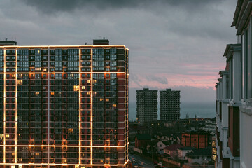 View of a high-rise building in the light of the lanterns of the night metropolis