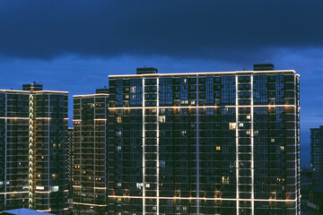 Modern night city, View of a high-rise building in the light of the lanterns of the night metropolis