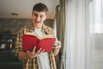 Young man caucasian teenager read book study at home education concept