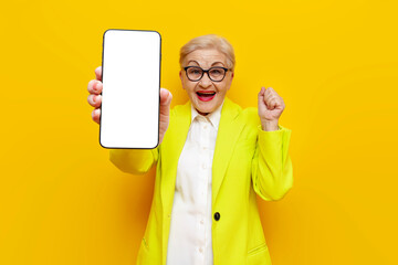 old businesswoman in glasses and formal wear showing blank smartphone screen and celebrating...