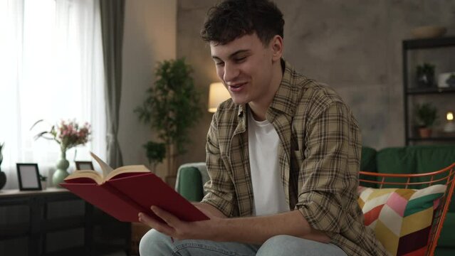 Young man caucasian teenager read book study at home education concept