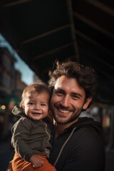Portrait of hipster father kissing his little daughter. Young dad is enjoying time with his child on yellow background.