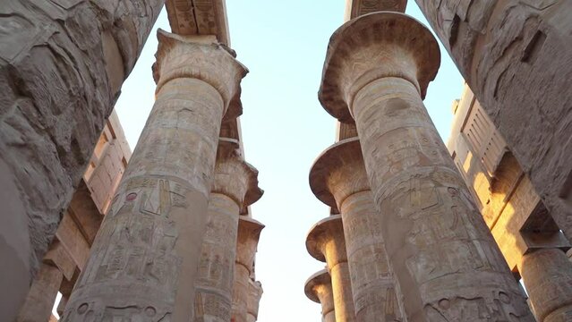 Ancient ruins of Karnak temple in Luxor. Egypt, Great Hypostyle Hall and clouds at the Temples of Karnak (ancient Thebes). Luxor, Egypt