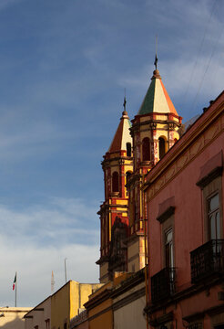 church with two peaks at sunrise with clouds in the background in the city center 