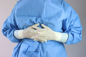 Health care professional with sterile surgical clothes and sterile gloves. Profissional positioned...