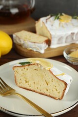 Piece of tasty lemon cake with glaze served on table, closeup