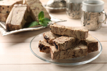 Tasty chocolate halva on wooden table, closeup
