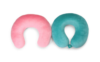 Pink and turquoise travel pillows isolated on white, top view