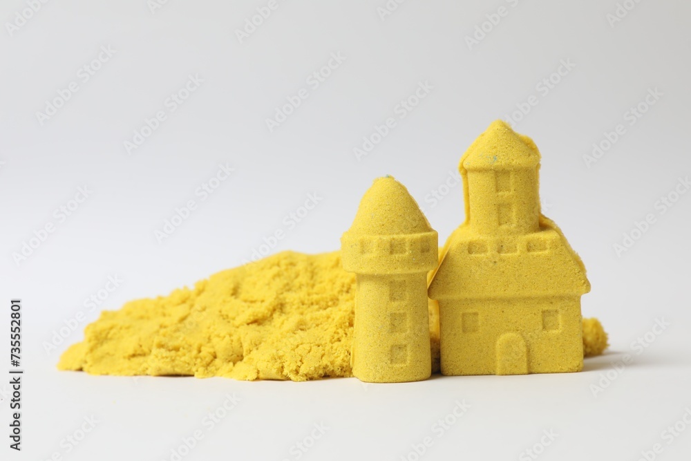 Canvas Prints Castle and tower made of yellow kinetic sand on white background