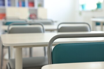 Empty school classroom with desks and chairs