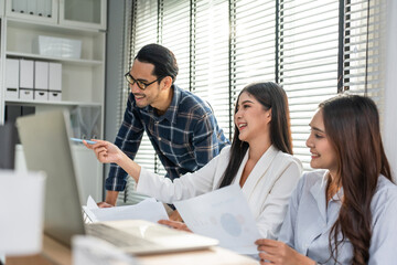 Young attractive businessman and businesswoman work in office workplace. 