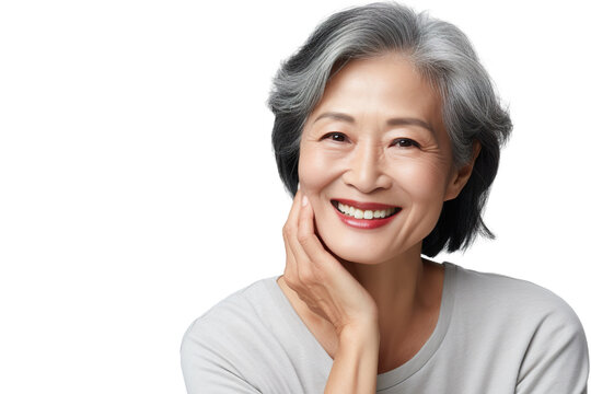 Happy middle aged mature asian woman, senior older 50 year lady looking at camera touching her face isolated on white close up face portrait PNG