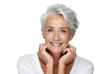 Happy middle aged woman, senior older 50 year lady looking at camera touching her face isolated on white close up face portrait