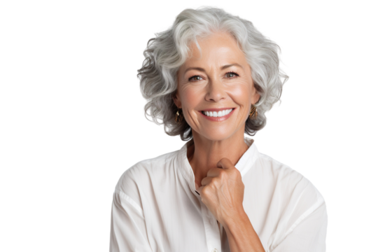 Happy middle aged woman, senior older 50 year lady looking at camera touching her face isolated on white close up face portrait