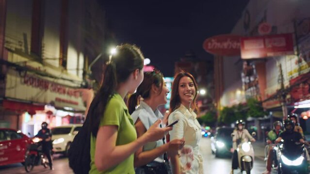Asian beautiful women friend traveling outdoors in the city at night.