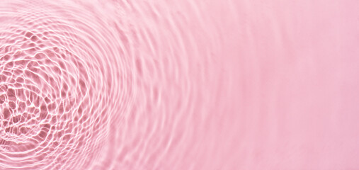 Water ripples on pink background. Abstract water ripples texture.