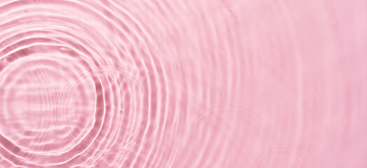 Water ripples on pink background. Abstract water ripples texture.