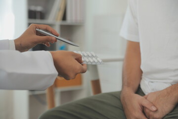 Male diseases. Man presses hands to his groin and suffering from pain, panorama, cropped, studio shot