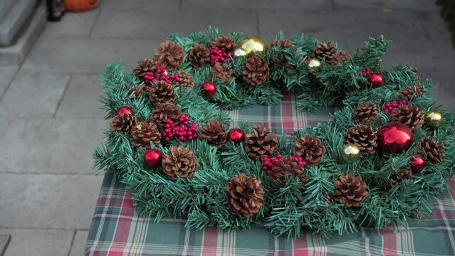 Close up of Christmas wreath,4k,slow motion,In English-speaking countries, wreaths are used typically as household ornaments, most commonly as an Advent and Christmas decoration.