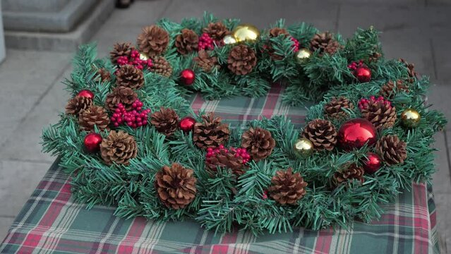 Close up of Christmas wreath,4k,slow motion,In English-speaking countries, wreaths are used typically as household ornaments, most commonly as an Advent and Christmas decoration.