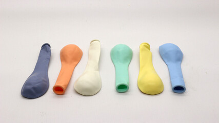 A pile of uninflated colorful balloons