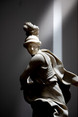 marble statue of a person with a sword