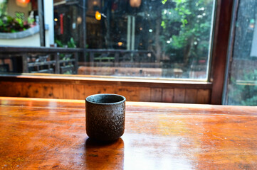 Japanese Tea cup on wooden table close-up