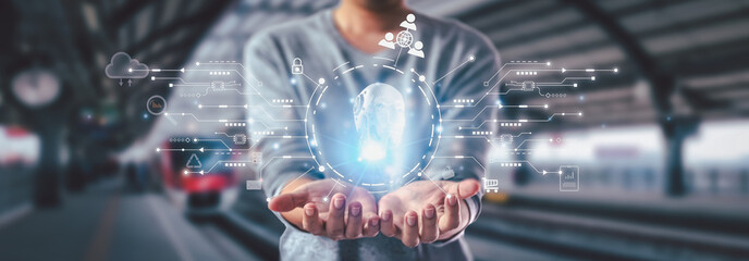 Businessman shows concept of future technology and internet connectivity network with AI at the helm. Graphic floating in the air on his hand. The concept of an unmanned electric train.