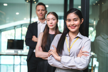 Portrait of smart young beautiful Asian business woman, successful female employee smiling with happy job, financial woman satisfied with the results of her work achievement in modern office