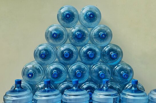 Stack of empty water bottles jugs closeup details