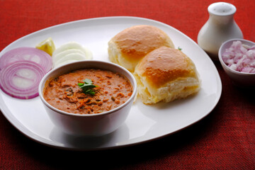 Pav Bhaji Indian spicy fast food with bread, onion and butter, Indian food, Indian Fast food.