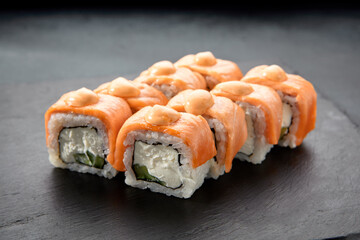Baked Philadelphia sushi rolls with spicy sauce, offering a creamy and tangy taste in each bite