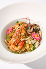Saute seafood in zucchini with a decorative plating on a white backdrop