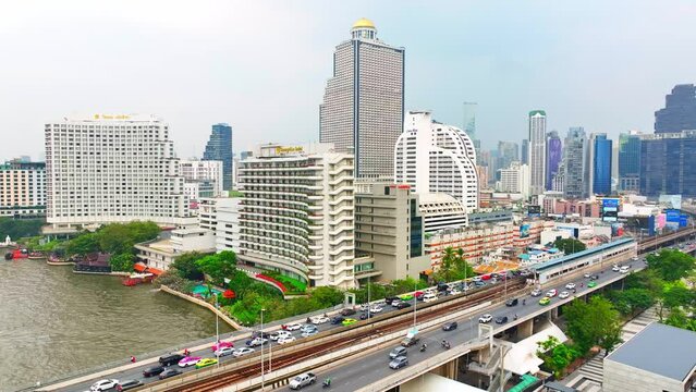 4K - Bangkok Thailand: Aerial view, Sunset casts a magical glow over Bangkok city and the tranquil Chao Phraya River, an enchanting sight. Journey and Tourism concept.
