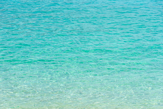Tropical summer beach and transparent blue sea water background.